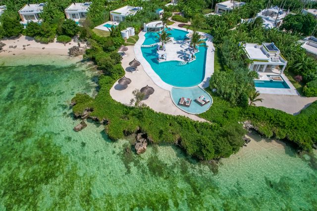 Aerial view of luxury beachfront villas with infinity pool